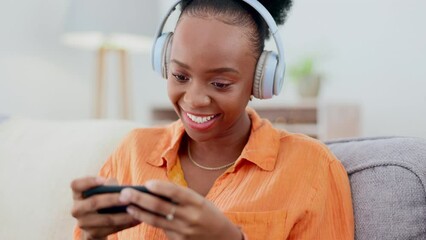 Sticker - Phone games, headphones and black woman on couch gaming, online competition or esports mobile app. Young cyberpunk, gamer or person play internet video game on cellphone and electronics in her lounge