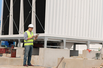 Wall Mural - Industry engineer under checking the industry cooling tower air conditioner is water cooling tower air chiller HVAC of large industrial building to control air system.