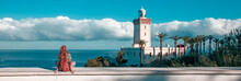 Woman Tourist Looking At Lighthouse Of Cap Spartel, Tanger, Morocco In Africa