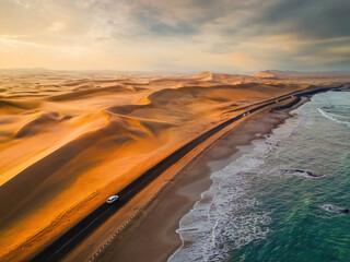 aerial top view of street road with namib desert safari, sand dune, coast sea in namibia, south afri