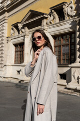 Wall Mural - Street style, autumn, spring fashion concept: fashionable woman wearing luxury beige coat, a top with razors and sunglasses