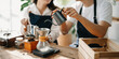 © Nuttapong punna - Cute couple, male and female barista working in coffee shop Barista working at cafe Alternative ways of brewing coffee.    .
