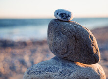 Rock Cairn At The Beach During Golden Hour