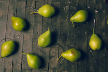 Pears To Eat Cut With A Wooden Knife And On A Brown Background