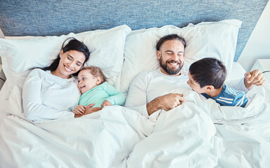 Canvas Print - Morning, relax and happy with family in bedroom for wakeup, affectionate and bonding from top view. Smile, care and sleeping with parents and children in bed at home for playful, happiness or support