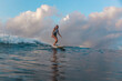 © Cavan Images - Female surfer on a wave
