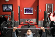 © Cavan Images - Fit millennial training pectoral muscle with bench press in gym