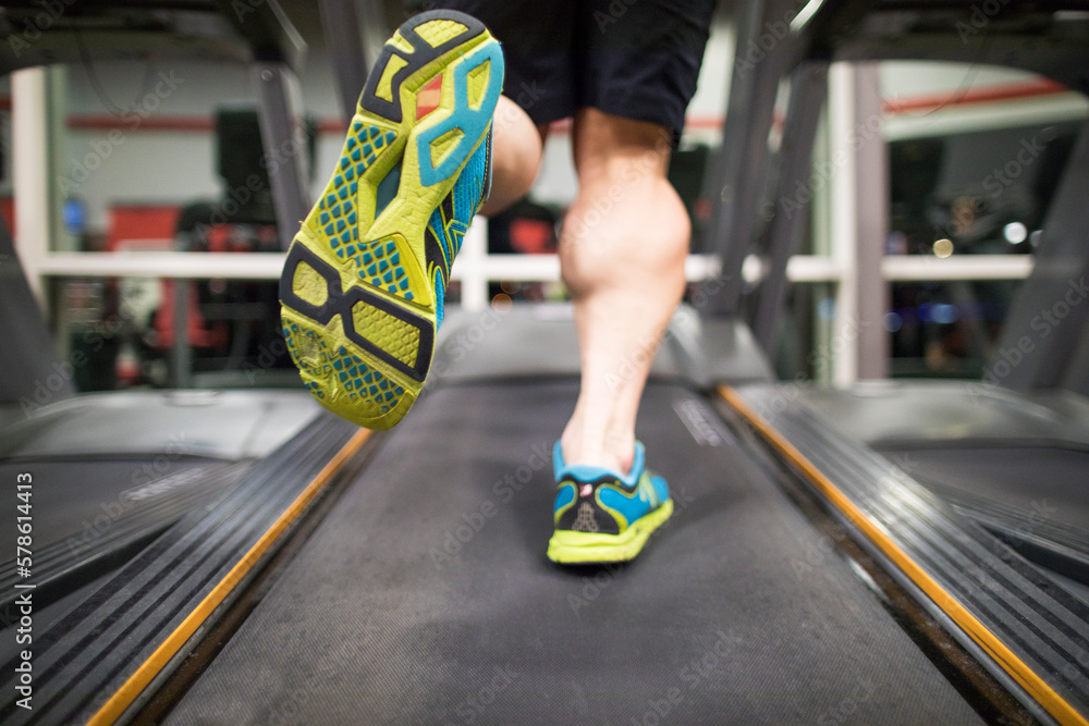 Treadmill Rear View Rear view of muscular man running on treadmill Stock Photo | Adobe Stock