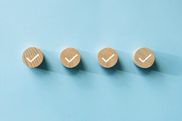 checklist concept, check mark on wooden blocks, blue background with copy space