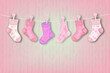 © Farnaces - Baby socks hanging on a clothesline. Baby shower concept. Generative AI