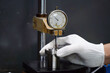 © Apicha - operator uses the indicator test dial on the stand for accurate measurements,Dial Test Indicator on the stand for accurate measuremen