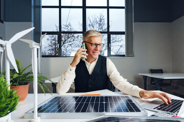 Wall Mural - Male mature architect working on an ecological construction project in office