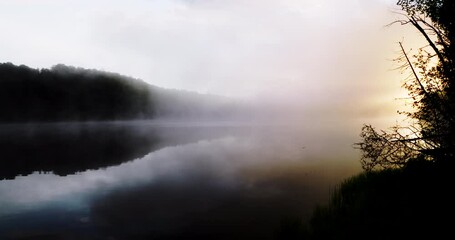 Wall Mural - Dark and dramatic misty lake during sunrise