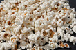 a bowl of freshly cooked popcorn on a black background, popcorn texture