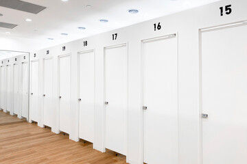 White theme minimalism changing room. White wall and wooden floor