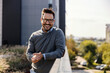 © Dusan Petkovic - Portrait of a happy man posing outdoors in financial district and smiling at the camera.