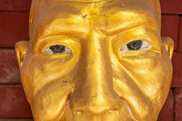 Wall Mural - Close-up of a golden Buddha statue at a temple in Mae Sot Thailand