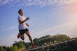 © Panumas - Silhouette of young man running sprinting on road. Fit runner fitness runner during outdoor workout with sunset background.