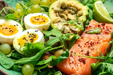 Wall Mural - Salmon fillet with fresh salad, grape, eggs and avocado. set of healthy food for keto diet