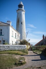 t Mary's Lighthouse with a garden under the blue sky, UK