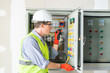 © ND STOCK - Electrician installing electrical wires and multimeter fuse switch box in hands of electrician detail
