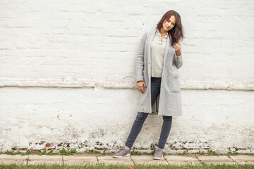 Wall Mural - portrait of a young stylish brunette woman in autumn park