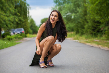 Sticker -  beautiful brunette woman sitting on the road