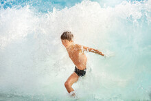 Dangerous Swimming In Storm Sea, Bodysurfing. Boy Swims In Rough Sea With Big Waves. Big Breaking Waves.