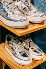 Wall Mural - silver unisex sneakers shoes on shelf display in shop mall store. Store Of Shopping Center. retail sale.