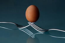 Egg Balanced On Forks Crossed