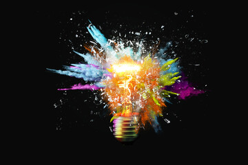 creative light bulb explodes with colorful paint splashes and shards of glass on a black background.