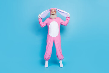 Poster - Full length photo of astonished man dressed pink rabbit costume arms hold ears impressed staring isolated on blue color background