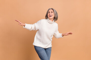 Sticker - Photo of dancing carefree middle aged pensioner lady dancing have fun relax overjoyed listen music active rhythm isolated on beige color background