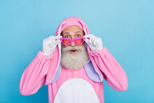 Photo Of Positive Man Dressed Pink Rabbit Costume Sunglass Hands Touching Glasses Unbelievable Sale Isolated On Blue Color Background