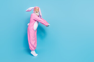 Sticker - Full length photo of shocked charming pensioner guy dressed bunny kigurumi jumping empty space isolated blue color background