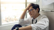 © NVB Stocker - Overload office worker. Alone stressed and sad  asian office worker is sitting beside error copy machine at the office.
