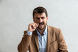 © Srdjan - Portrait of young successful businessman leader employer boss in suit standing in office looking at camera