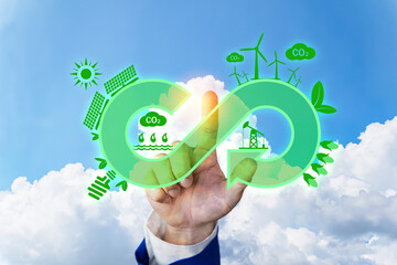 Business man touching recycling symbol on touch screen, Green Eco-friendly and circular economy concept. Infinity arrow recycling symbol with green grass texture