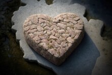 A Heart Shaped Cutout Of Ground Pork On A Slab Of Stone. Generative AI