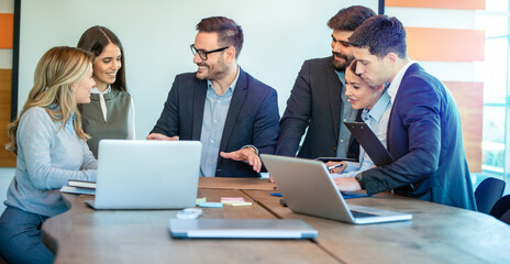 Wall Mural - Corporate male business executive leader having discussion with employee staff about marketing discussion, planning strategy and sharing ideas at meeting in office.