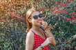 © Todayphoto - Beautiful girl near the bush with red berries