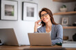 © sepy - Attractive middle aged woman wearing casual clothes and using cellphone and laptops for work