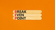 BEP break even point symbol. Concept words BEP break even point on wooden stick on a beautiful orange table orange background. Business and BEP break even point concept. Copy space.