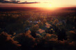Bird's-eye view of a scenic sunset over the forest hills with toned dramatic colors.