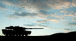 © hamara - Silhouette of army tank at sunset sky background. Military machinery.