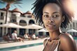 young african american adult woman at a beach at a resort hotel swimming pool area 