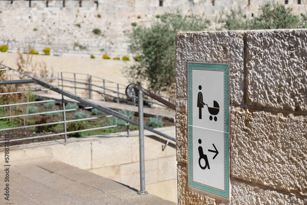 Direction sign for wheelchair and pram access in park, closeup