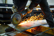 © nordroden - Worker cuts metal with abrasive disk in plant workshop