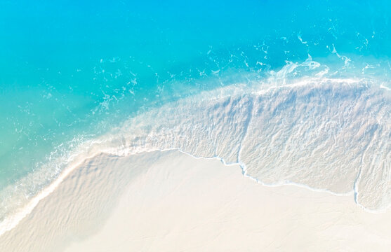 aerial view with beach in wave of turquoise sea water shot, top view of beautiful white sand backgro