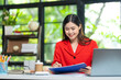 © ND STOCK - Portrait of pretty cheerful girl smiling while working on laptop in office